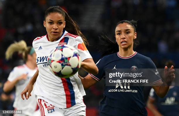 Lyons French forward Delphine Cascarino fights for the ball with Paris Saint-Germain's French defender Sakina Karchaoui during the UEFA Women's...