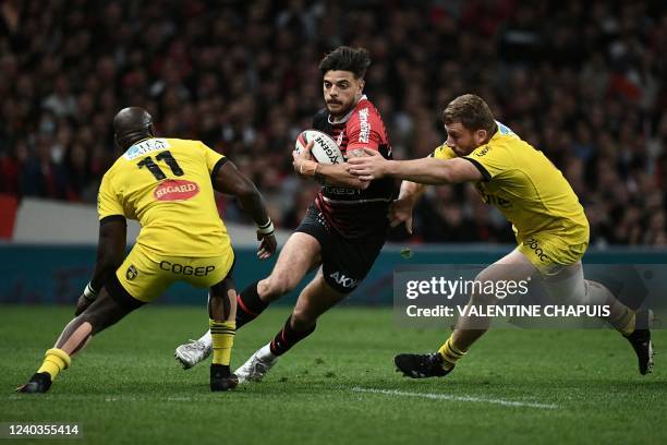 Toulouse's French fly-half Romain Ntamack runs with the ball during the French Top 14 rugby union match between Toulouse and La Rochelle at The...