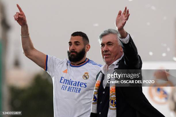 Real Madrid's French forward Karim Benzema and Real Madrid's Italian coach Carlo Ancelotti wave to supporters on the Plaza Cibeles square in Madrid,...