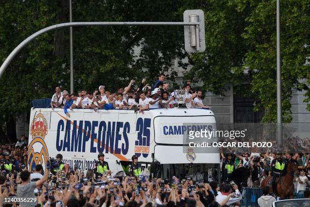 Real Madrid's players celebrate as they arrive on a bus on the Plaza Cibeles square in Madrid, after Real Madrid CF won the Spanish League football...