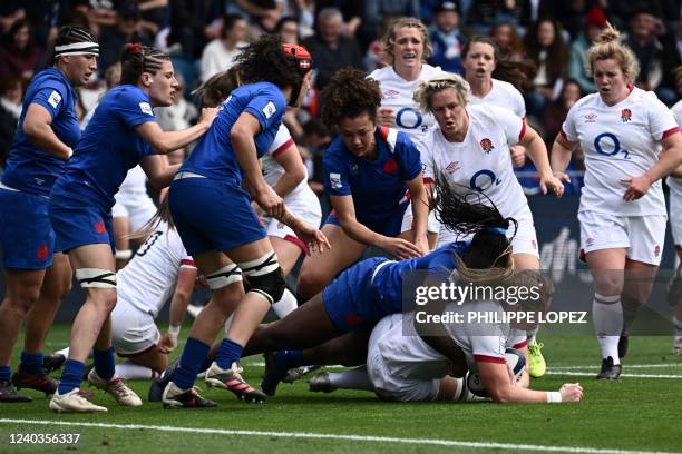 England's number-8 Poppy Cleall is tackled during the Six Nations international women's rugby union match between France and England at Jean Dauger...