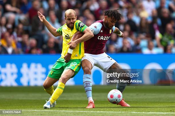 Teemu Pukki of Norwich City tangles with Tyrone Mings of Aston Villa during the Premier League match between Aston Villa and Norwich City at Villa...