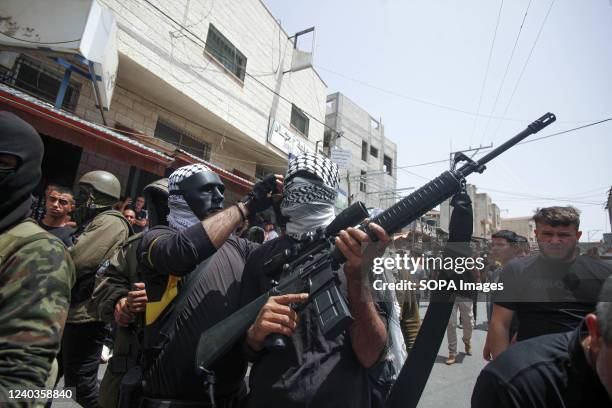 Gunmen from the Al-Aqsa Martyrs Brigades of the Fatah movement headed by Mahmoud Abbas take part during the funeral of the 27-year-old Palestinian...