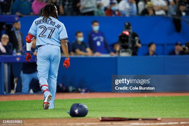 Vladimir Guerrero Jr. #27 of the Toronto Blue Jays walks away from his bat and helmet after striking out in the fifth inning of their MLB game...