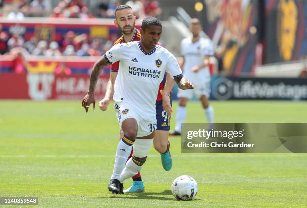 Douglas Costa of the Los Angeles Galaxy pushes the ball up field against Justin Meram of Real Salt Lake during the first half of their game April 30,...