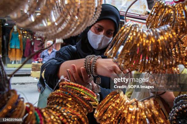 Kashmiri woman seen buying Bangles ahead of the Muslim festival Eid-al-Fitr at a local market in Srinagar. Markets across the Muslim world witness...