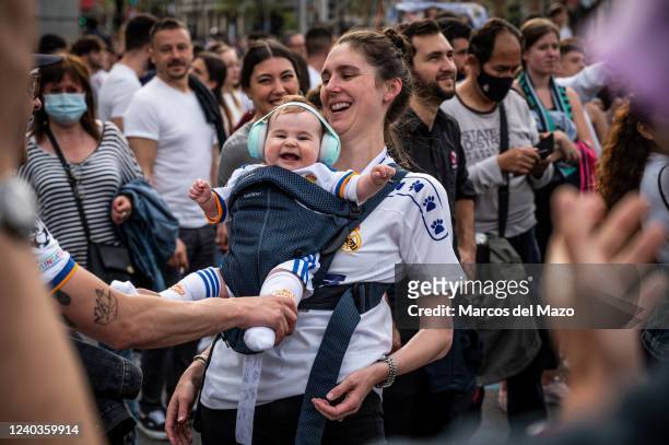 Mother with her baby celebrating with other Real Madrid fans in Plaza de Cibeles the 35th La Liga national title that Real Madrid team won following...