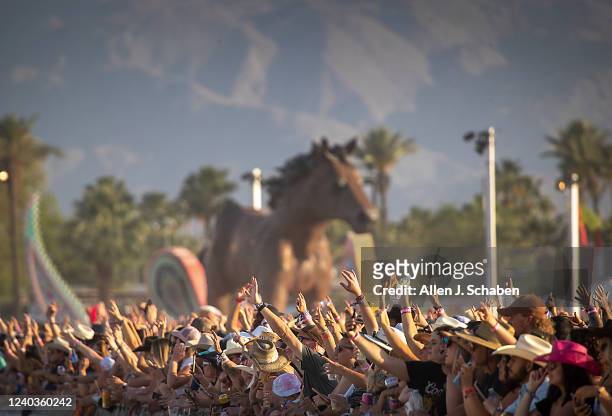 The crowd cheers as Midland performs at sunset on the Mane Stage on the first day of the three-day Stagecoach Country Music Festival at the Empire...
