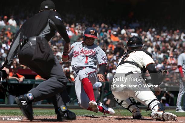 Cesar Hernandez of the Washington Nationals is tagged out at home plate by Curt Casali of the San Francisco Giants in front of umpire Adam Beck...