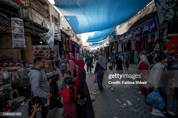 People shop in a market ahead of the Eid al-Fitr holiday in Jabalia refugee camp, north of Gaza City on April 30, 2022 in Gaza City, Gaza....