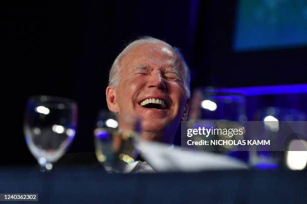 President Joe Biden laughs during the White House Correspondents' Association gala at the Washington Hilton Hotel in Washington, DC, on April 30,...