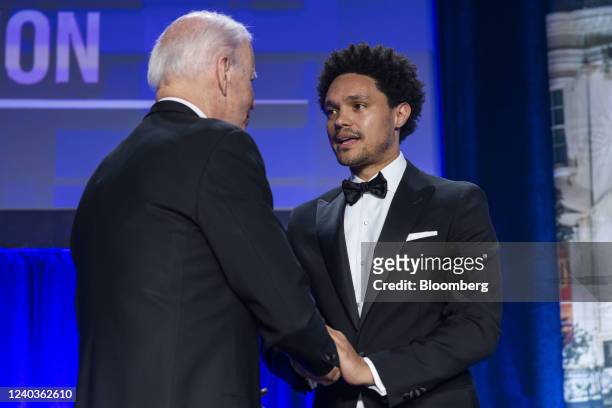 President Joe Biden, left, shakes hands with Trevor Noah, host of "The Daily Show" on Comedy Central, during the White House Correspondents'...