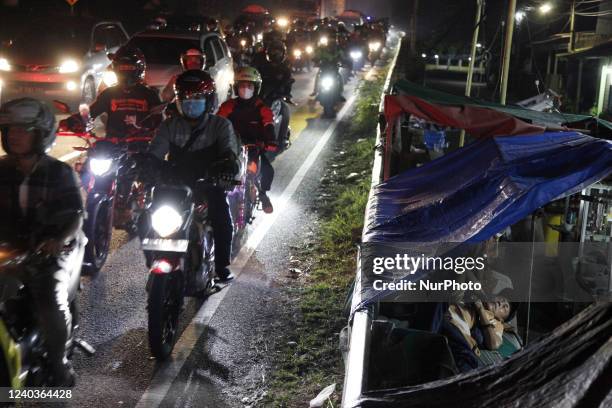 People ride their motorcycle for hundred of kilometers and long traffic jams, in Karawang city, West Java, on April 30 as they heading to their...