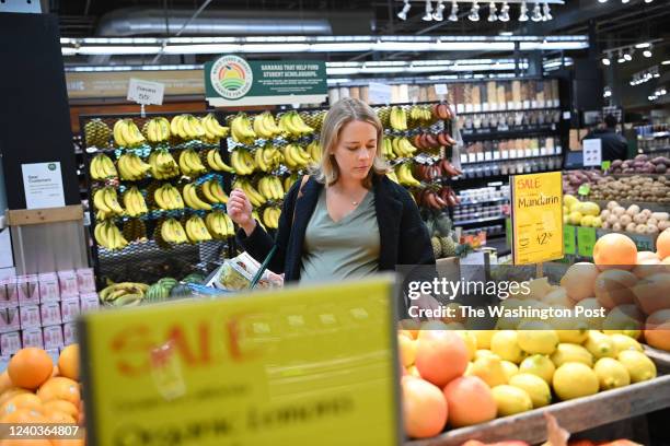 Kelly Hayes looks at produce that is on sale as she shops at Whole Foods Market in the Tenleytown neighborhood on Thursday April 28, 2022 in...