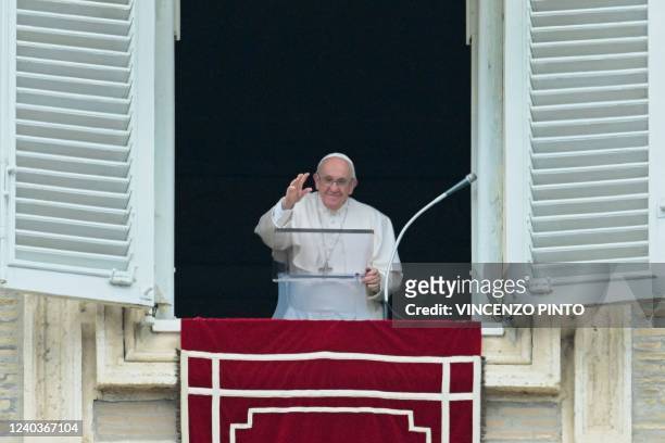 Pope Francis waves as he prepares to deliver his Sunday Regina Coeli prayer from the window of his study overlooking St.Peter' Square at the Vatican...