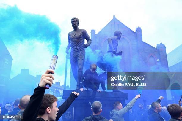 Supporters gather beside the Holy Trinity statue of legendary players Alan Ball, Howard Kendall and Colin Harvey, outside the ground ahead of the...