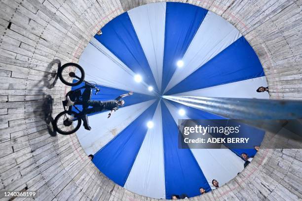 This photo taken on April 30, 2022 shows a rider of the "wall of death", locally known as a "Tong Setan", performing inside a six-metre high wall at...