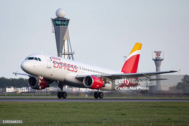 Iberia Express Airbus A320 aircraft as seen departing from Amsterdam Schiphol AMS EHAM airport. The passenger jet plane is passing in front of the...