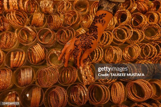 Shoppers check out ornaments at a market area ahead of Eid al-Fitr, which marks the end of the Muslim's holy festival of Ramadan in Srinagar on May...