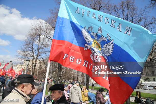 Man holds a flag of of self-proclaimed Lugansk People's Republic during the rally, hosted by Communist Party of Russia, marking the Labour Day, May...