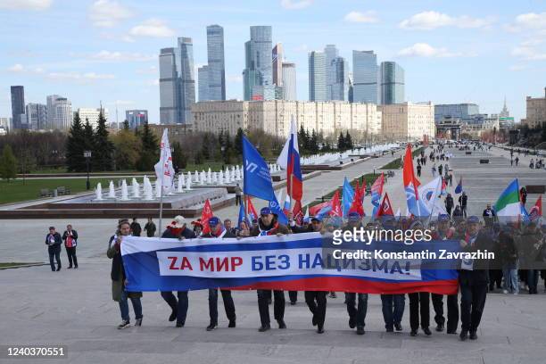Federation of Independent Trade Unions of Russia's activists carry the poster with "Z" letter, a symbol of the military invasion on Ukraine as the...