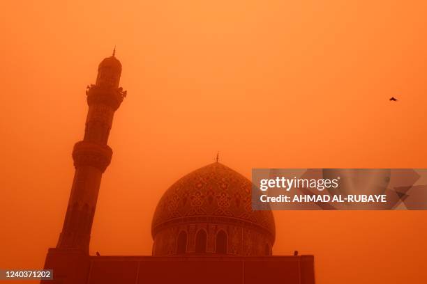 Photograph taken on May 1, 2020 shows the 17 Ramadan mosque in the Iraqi capital Baghdad during a severe sand storm. - Flights were grounded today...