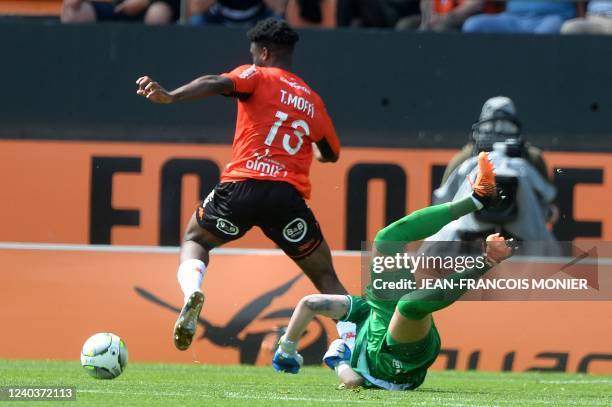 Lorient's Nigerian forward Terem Moffi scores next to Reims' Serbian goalkeeper Predrag Rajkovic during the French L1 football match between FC...