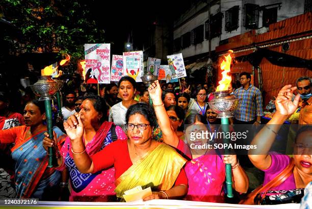 Sex workers shout slogans while marching with burning torches during the eve of International Labor Day. Sex workers of Sonagachi Kolkata, the...