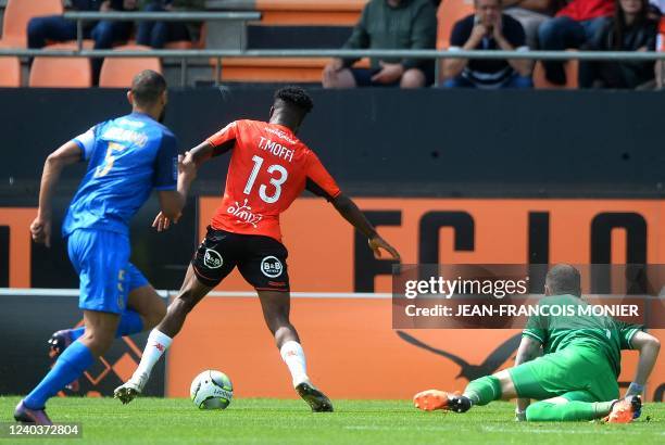 Lorient's Nigerian forward Terem Moffi scores a goal next to Reims' Serbian goalkeeper Predrag Rajkovic during the French L1 football match between...