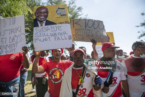 Mine workers and members of Congress of South African Trade Unions gather near Royal Bafokeng Stadium during a demonstration to mark International...