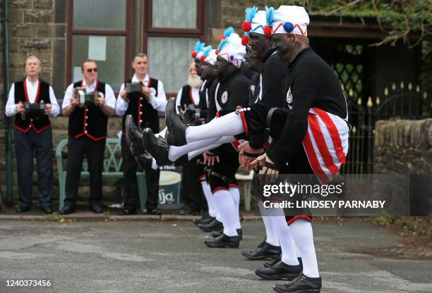 The Britannia Coconut Dancers of Bacup, wearing controversial makeup colouring "blackface", dance outside The Crown Inn to celebrate May Day in the...