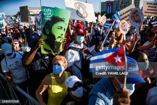 Demonstrator carries a poster with an image of late Cuban president Fidel Castro during the commemoration of May Day to mark the international day of...