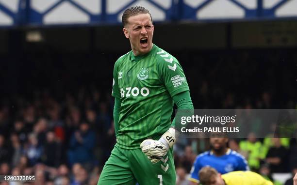Everton's English goalkeeper Jordan Pickford reacts to making a save during the English Premier League football match between Everton and Chelsea at...