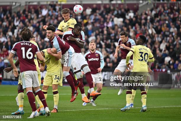 Arsenal's English defender Rob Holding heads the ball and scores his team first goal during the English Premier League football match between West...