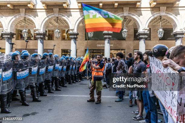 People with the peace banner try to calm the protest by avoiding further unrest.Protestors clashed with riot police during the demonstration of...