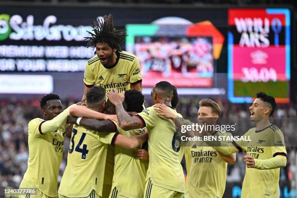 Arsenal's English defender Rob Holding celebrates with teammates after scoring a goal during the English Premier League football match between West...