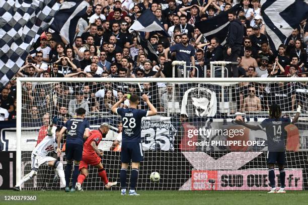 Nices Algerian forward Andy Delort kicks the ball and scores a goal during the French L1 football match between Girondins de Bordeaux and OGC Nice at...