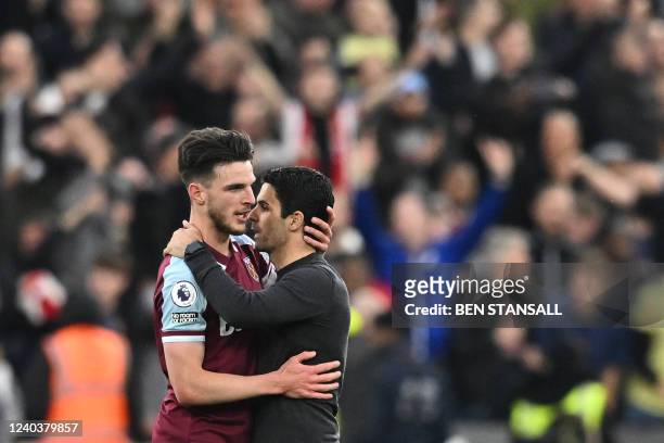 Arsenal's Spanish manager Mikel Arteta congratulates West Ham United's English midfielder Declan Rice at the end of the English Premier League...