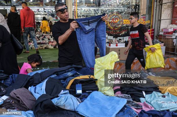 Palestinians shop at a market in Rafah in the southern Gaza Strip, on May 1 on the eve of Eid al-Fitr which marks the end of the Muslim fasting month...