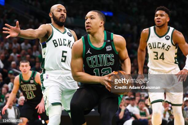 Grant Williams of the Boston Celtics drives to the basket past Jevon Carter of the Milwaukee Bucks during Game One of the Eastern Conference...