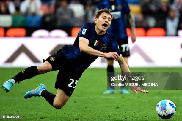 Inter Milan's Italian midfielder Nicolo Barella falls during the Serie A football match between Udinese and Inter Milan at Friuli stadium in Udine on...