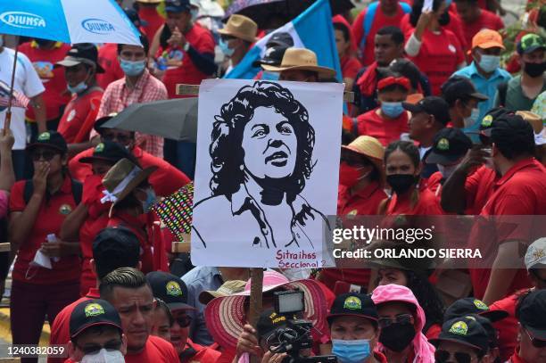 Employees of the Workers' Union of the Honduran Institute of Social Security hold a poster of the murdered indigenous leader Berta Caceres during the...