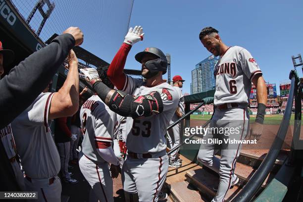 Christian Walker of the Arizona Diamondbacks is congratulated by his teammates after hitting a home run against the St. Louis Cardinals in the fourth...