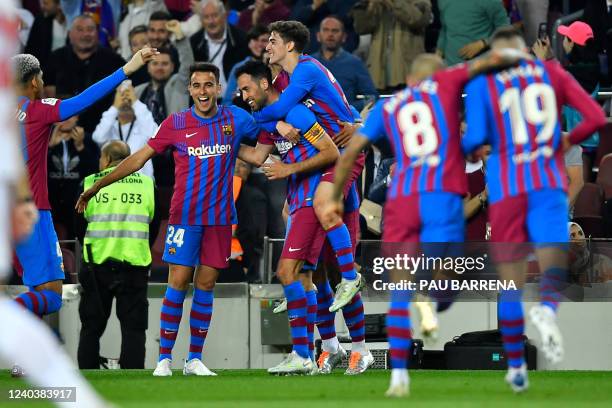 Barcelona's Spanish midfielder Sergio Busquets celebrates with teammates after scoring the second goal during the Spanish League football match...