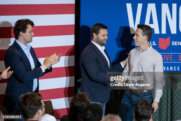 Conservative activist Charlie Kirk applauds as J.D. Vance, a Republican candidate for U.S. Senate in Ohio, shakes hands with Sen. Josh Hawley at a...