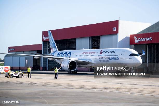 An Airbus A350-1000 aircraft taxis outside a hangar at Sydney international airport on May 2 to mark a major fleet announcement by Australian airline...