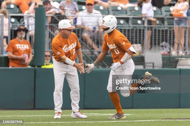 Texas Longhorns infielder Trey Faltine is congratulated by head coach David Pierce after hitting a home run during the game between Texas Longhorns...