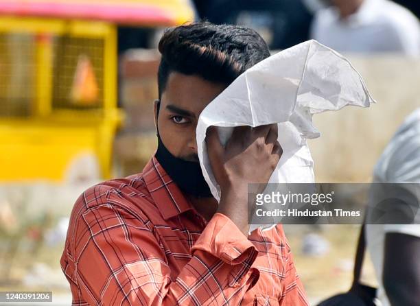 Pedestrians on a hot summer day at Connaught Place, on May 1, 2022 in New Delhi, India.