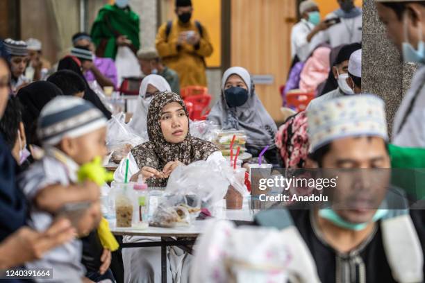 Muslim eat after Eid al-Fitr prayers at the Foundation of the Islamic Centre of Thailand, the largest mosque in Bangkok on May 02, 2022 in Bangkok,...