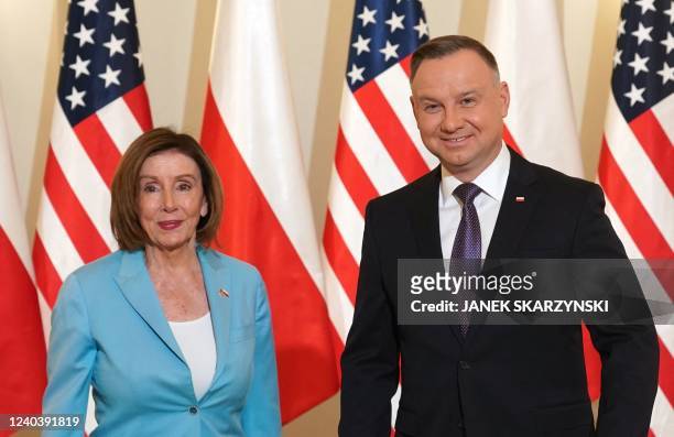 Speaker of the House Nancy Pelosi stands next to Polish President Andrzej Duda as they meet in Warsaw on May 2, 2022.